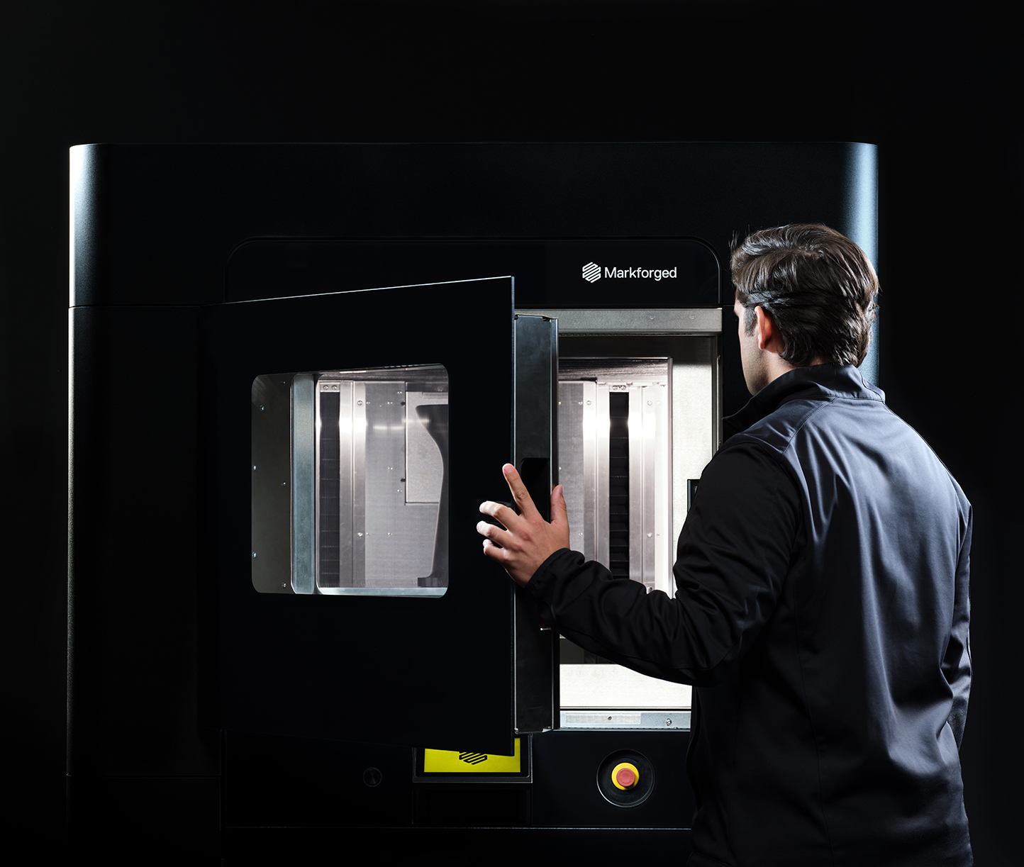 An Engineer using the Markforged FX20 3D printer